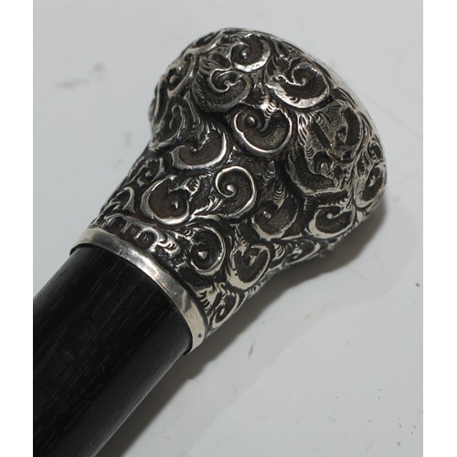 1338 - A George V silver mounted walking stick, domed pommel engraved with leafy scrolls, ebonised cane, 92... 