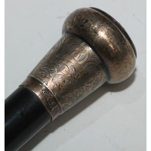 1338 - A George V silver mounted walking stick, domed pommel engraved with leafy scrolls, ebonised cane, 92... 