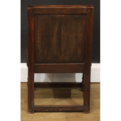 1402 - A 17th century style oak child’s wainscot side chair, the back carved with a frieze of lunettes abov... 