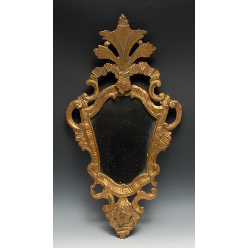 1400 - A 19th century giltwood cartouche shaped looking glass, in the Baroque taste, plain mirror plate, 71... 