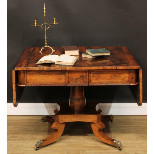 1775 - A Regency rosewood sofa table, rounded rectangular top with fall leaves above a pair of frieze drawe... 