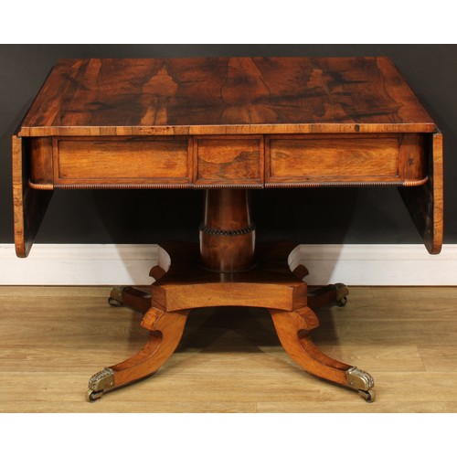 1775 - A Regency rosewood sofa table, rounded rectangular top with fall leaves above a pair of frieze drawe... 