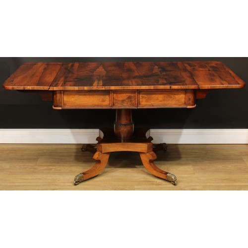 1775 - A Regency rosewood sofa table, rounded rectangular top with fall leaves above a pair of frieze drawe... 