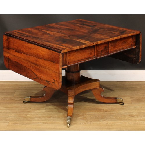 1775 - A Regency rosewood sofa table, rounded rectangular top with fall leaves above a pair of frieze drawe... 