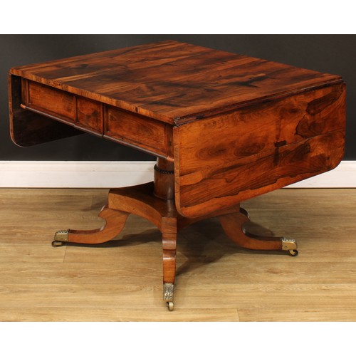 1775 - A Regency rosewood sofa table, rounded rectangular top with fall leaves above a pair of frieze drawe... 