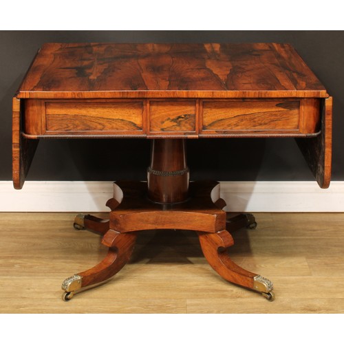 1775 - A Regency rosewood sofa table, rounded rectangular top with fall leaves above a pair of frieze drawe... 