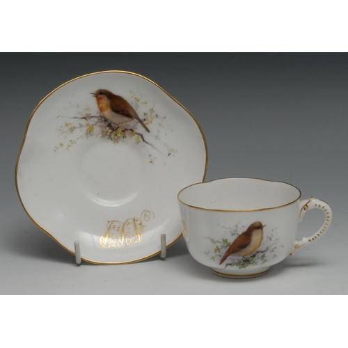 648 - A Royal Worcester teacup and saucer,  painted with birds perched on blossoming branches, gilt initia... 