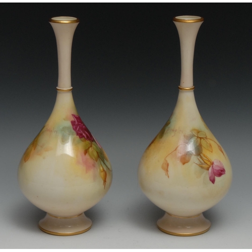 573 - A pair of Royal Worcester bottle vases, painted by Sedgley, with roses in Hadley style, 24.5cm high,... 