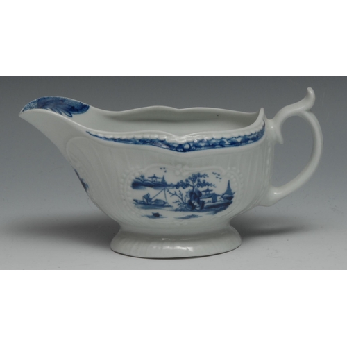 653 - A small Worcester Fisherman and Billboard Island pattern strap fluted  sauce boat, painted in blue w... 