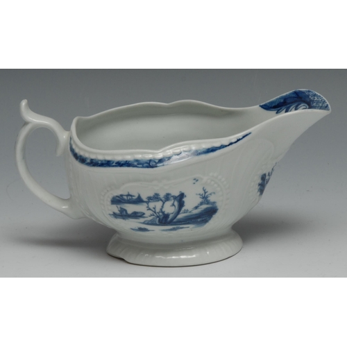 653 - A small Worcester Fisherman and Billboard Island pattern strap fluted  sauce boat, painted in blue w... 