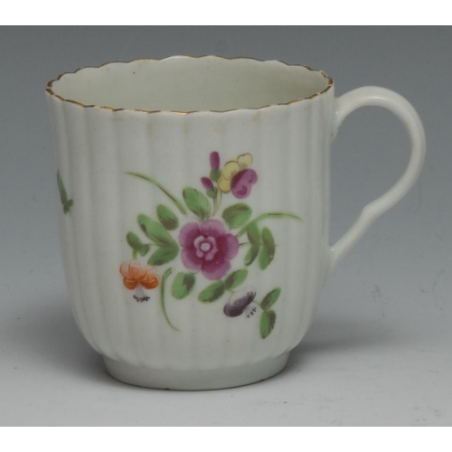 668 - A Worcester reeded French shaped coffee cup, painted with colourful flowers and a ladybird, gilded b... 