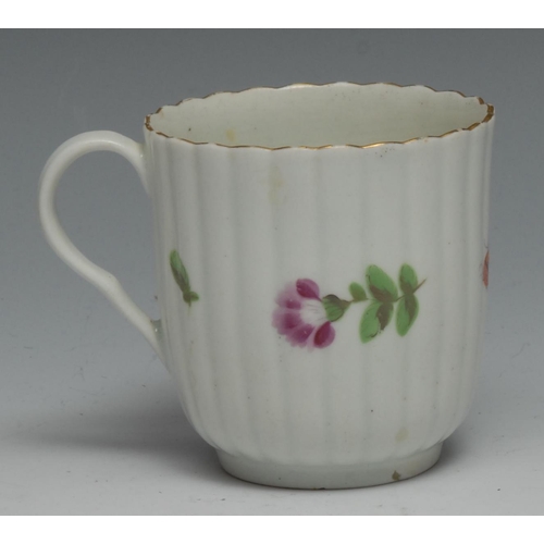 668 - A Worcester reeded French shaped coffee cup, painted with colourful flowers and a ladybird, gilded b... 