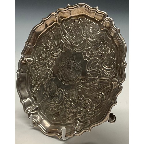 121 - A George II silver shaped circular waiter, fluted border, the field chased with a band of flowers, C... 