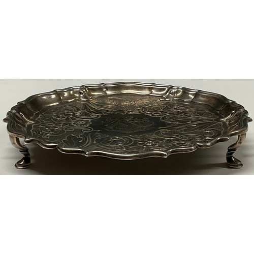 121 - A George II silver shaped circular waiter, fluted border, the field chased with a band of flowers, C... 