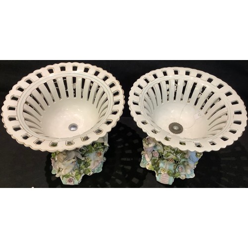 36 - A pair of large Sitzendorf porcelain table centrepieces, the shaped circular openwork baskets suppor... 