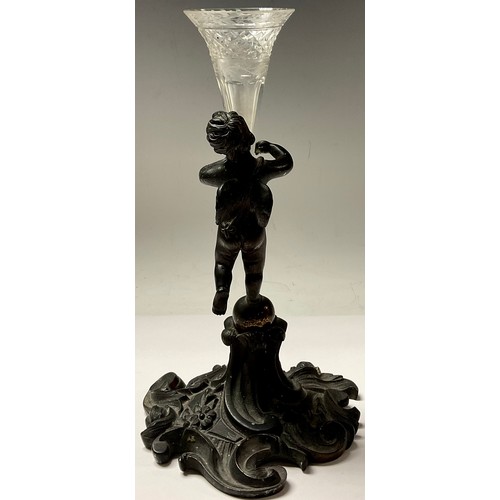 132 - A 19th century bronze epergne, modelled as a putti holding cut glass trumpet vase, 21.5cm high