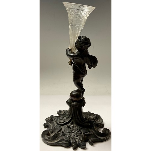 132 - A 19th century bronze epergne, modelled as a putti holding cut glass trumpet vase, 21.5cm high