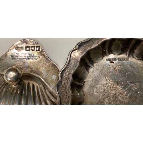 168 - A silver scallop shaped dish, London 1921; a shaped circular trinket dish, Sheffield 1946; a silver ... 