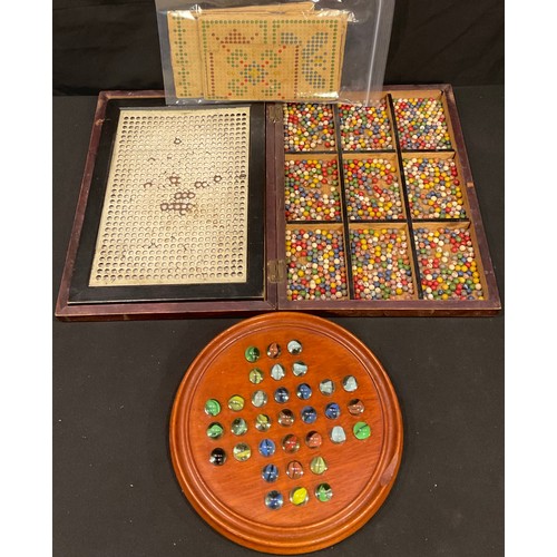 205 - An early 20th century Diamant Mosaic set; a mahogany solitaire board with marbles (2)