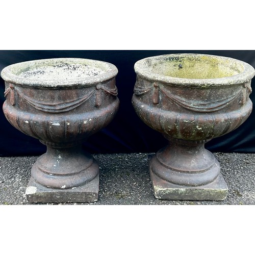 3154 - A pair of pedestal campana shaped garden vases, in relief with swags, square bases


**Please note t... 