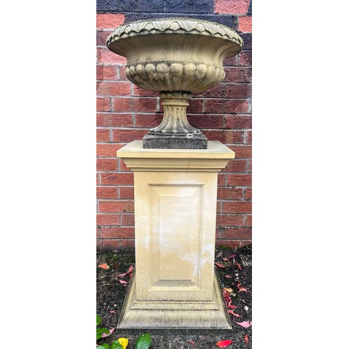 3170 - A fluted garden urn and pedestal, 105cm high, 46cm in diameter, the base 40.5cm wide

**Please note ... 