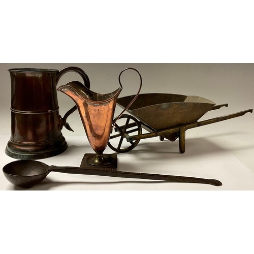 223 - A Georgian copper tankard; a jug; a brass wheelbarrow; an 18th century bronze ladle (4)