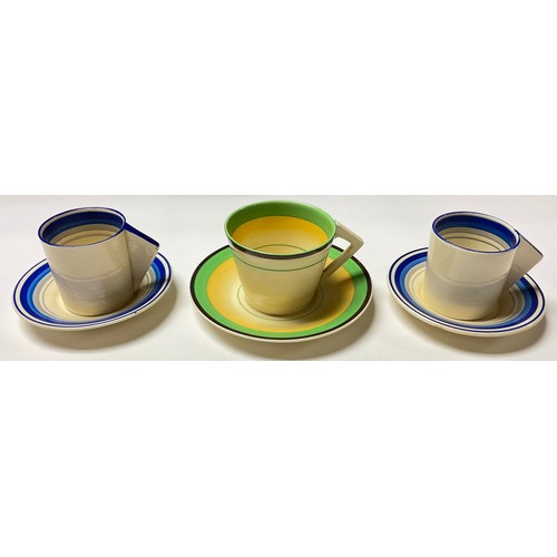 351 - A Clarice Cliff coffee cup and saucer, angular handle, painted with bands of yellow, green and brown... 