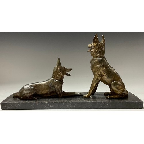 380 - A French Art Deco spelter dog group, pair of Alsatian dogs at rest, canted rectangular black marble ... 