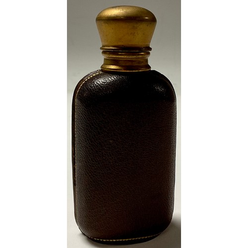 190A - A 19th century burnished gilt metal and tooled leather scent bottle, hinged cover enclosing a stoppe... 