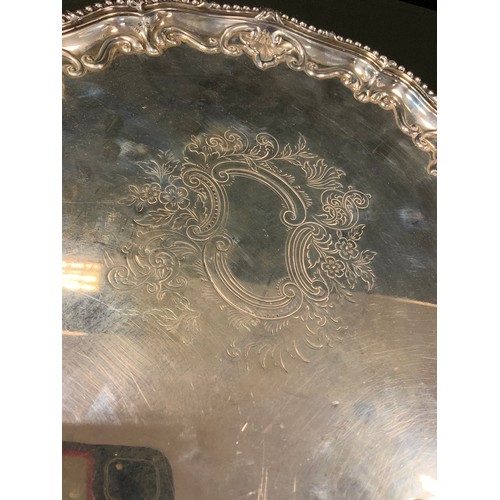 95 - A Victorian silver salver, engraved and chased to centre, the rim embossed with scrolls, beaded rim,... 