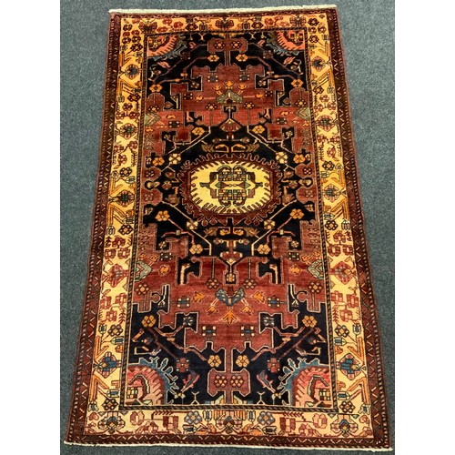 63 - A North-West Persian Tafresh rug / carpet, knotted in subdued tones of burgundy, indigo, and blue, o... 