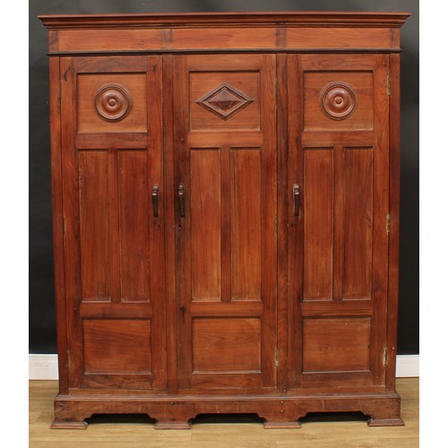 65 - An 18th century style black walnut armoire or wardrobe, outswept cornice above three panel doors, th... 