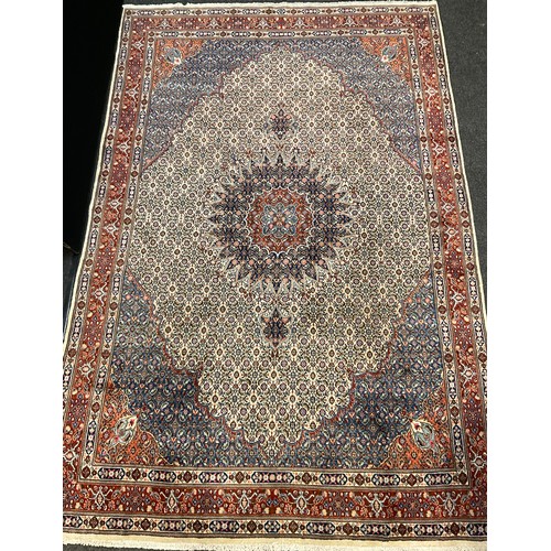 72 - A Persian Moud rug / carpet, hand-knotted with an intricate medallion within and field of stylised f... 