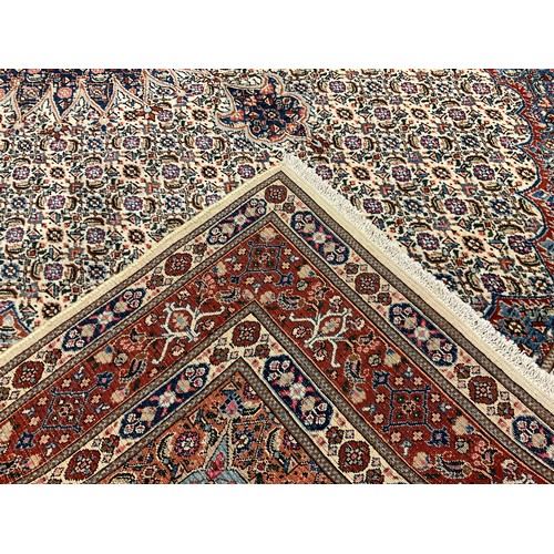 72 - A Persian Moud rug / carpet, hand-knotted with an intricate medallion within and field of stylised f... 