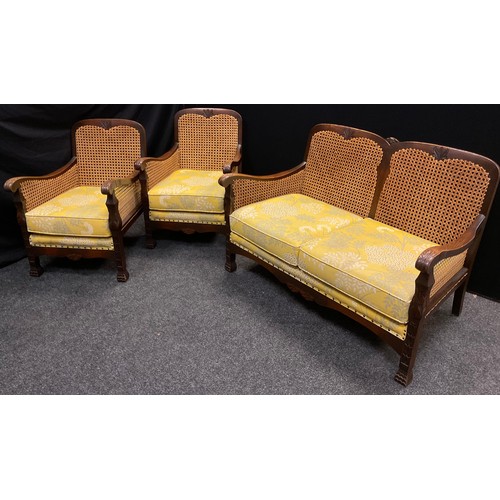 75 - An oak, Bergere conservatory suite, comprising three seat sofa, and pair of armchairs, (3).