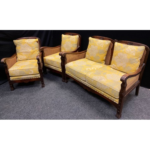 75 - An oak, Bergere conservatory suite, comprising three seat sofa, and pair of armchairs, (3).