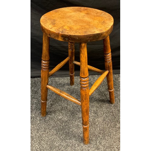 88 - An early 20th century Elm stool, four turned legs, 60cm high, 30cm diameter.