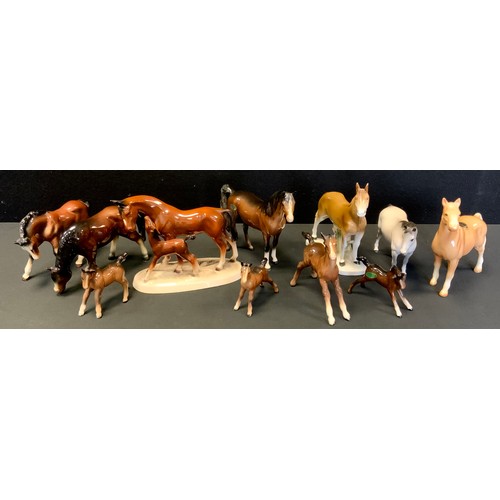 126 - A Beswick Model, Swish tail horse, matt grey;  others Brown gloss mare;  foals, etc other Continenta... 