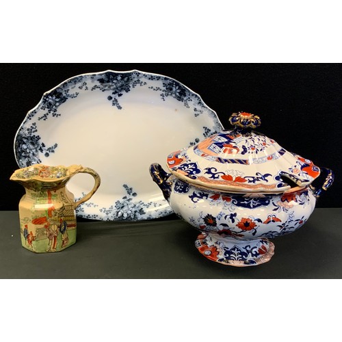 127 - A Large Ironstone soup tureen and cover, Bandana ware milk jug;  oval meat plate (3)