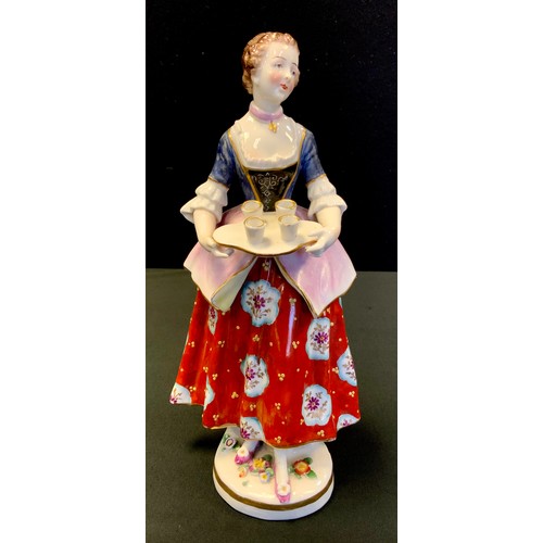 145 - A 19th century continental porcelain figure, Girl with serving tray, painted in red, purple and blue... 