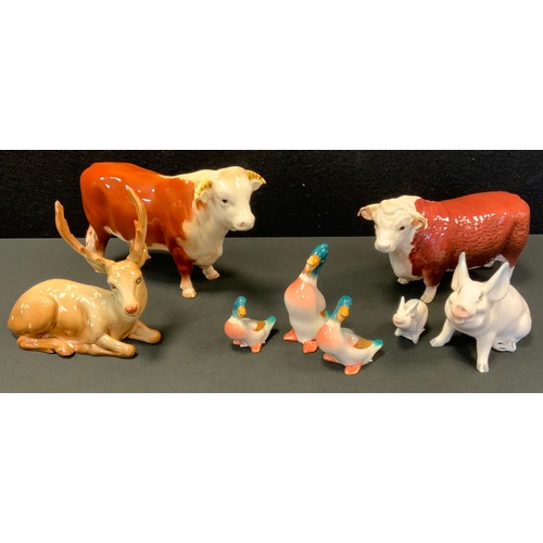 168 - A Beswick sitting stag ,No 954, 15cm high; Champions of champions model cow; etc (8)