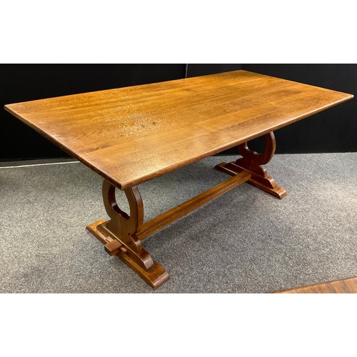 170 - A 20th century solid oak trestle dining table, Lyre-shaped supports, square stretcher, 73cm tall x 1... 