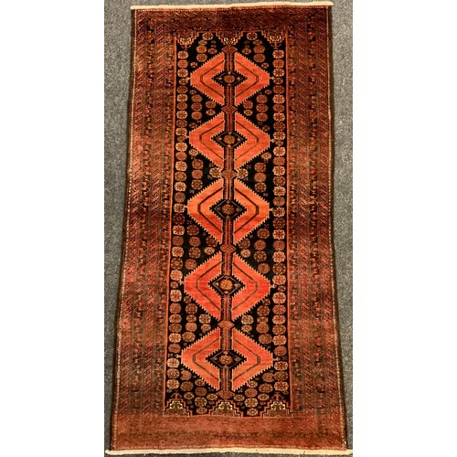 182 - A North-East Persian Meshed Belouch rug / carpet, 185cm x 90cm.