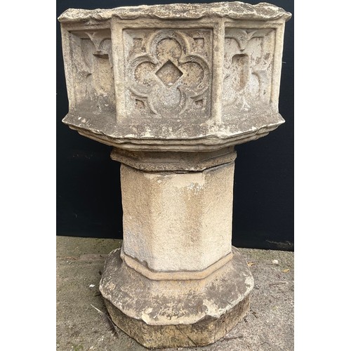 1769B - A 19th century carved stone and composition octagonal church font, carved with a gothic style tracer... 