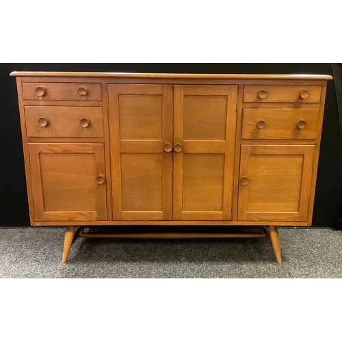 214 - A mid 20th century Ercol sideboard, elm plank top, two large and two small panelled doors, panelled ... 