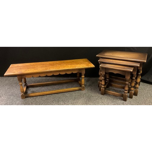 217 - A mid 20th century oak coffee table, 35cm tall x 106.5cm wide x 35cm deep;  a similar set of three n... 