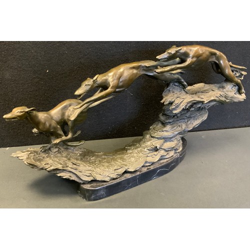 220 - A 20th century cast bronze sculpture, as three greyhounds racing at speed integral naturalistic base... 