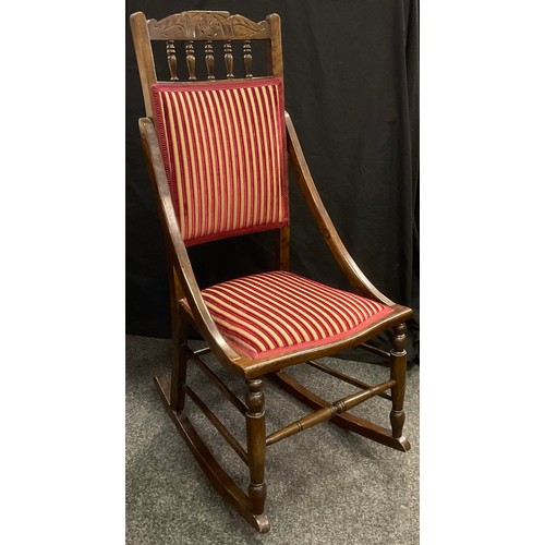 231 - An Edwardian walnut rocking chair, 102cm tall.