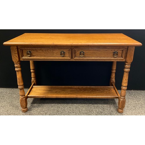 252 - A Kimberley Furniture ‘Old Charm’ style oak console hall table, over-sailing top, pair of short draw... 