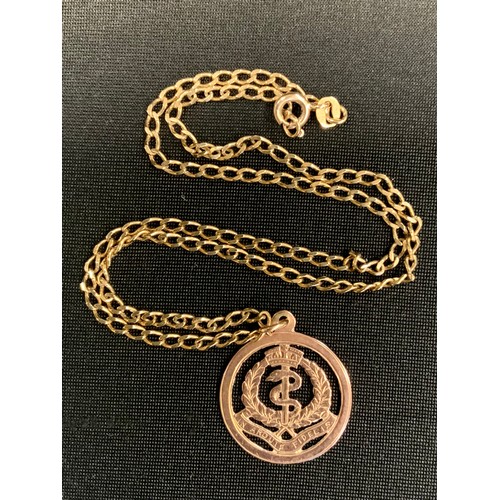 406 - An Army Medical Corp 9ct gold pendant, stamped 9ct, suspended from a later curb link necklace, stamp... 